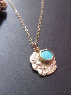 Necklace details: * The necklace and the pendant made from 14 karats solid Yellow gold. * Chain length 17.7inch/ 45cm. * 1 Turquoise. * Pendant width: 0.55x0.63inch/ 14x16cm. In pictures 7-10, you can see more examples of turquoise necklaces. Unusual handmade design for a classic gold pendant with Turquoise. Chain available in all sizes, color gold, karat, and Matte or Shining finish. Each pendant is custom made unique and will have slight variations in shape. IF YOU WANT A CUSTOM necklace pleas Dainty Yellow Gold Turquoise Necklace For Gift, Handmade Dainty Gold Turquoise Necklace, Dainty Handmade Gold Turquoise Necklace, Gold Turquoise Pendant Necklace With Gemstone, Gold Turquoise Necklace With Round Pendant, Gold Turquoise Gemstone Necklace In Dainty Style, Blue Hammered Jewelry As Gift, Blue Hammered Jewelry As A Gift, Blue Hammered Jewelry For Gift