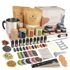 the contents of a coffee making kit are displayed on a white surface, including cups and spoons