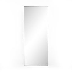 a mirror that is on top of a white wall with a light in the middle