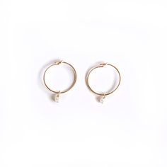 Our newest dainty hoops! Approximately 15mm and very light and comfortable! *Sold as a pair* Featuring a 2mm stone hanging from the hoop to create just the right amount of shimmer. One of our most popular hoops! Super easy to take on and off. Gold Filled so you can shower and swim with them on. Tarnish resistant. Handmade in California. Worn everywhere. Adjustable Small Hoop Pearl Drop Jewelry, Small Hoop Pearl Earrings For Everyday, Adjustable White Pearl Hoop Earrings, Everyday Small Hoop Pearl Earrings, Dainty Adjustable Hoop Earrings With Pearl Drop, Dainty Small Hoop White Earrings, Handmade Hoop Pearl Earrings, Hypoallergenic Small Hoop Pearl Earrings, White Huggie Hoop Earrings With Ear Wire