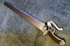 a knife that is laying on the ground with it's blade sticking out of it