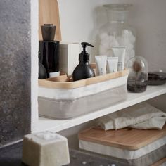 a shelf with soap, lotion and other items on it