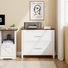 a computer desk with a printer on top of it next to a white cabinet and window