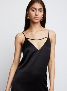 Our Leilani, is a skim slip dress with feather hemline adds a feminine edge to this body skimming slip dress silhouette, crafted in Hammered Satin. Spaghetti straps with horizontal detailing enhance the décolletage. Hemline hits right below the knee. 86% Triacetate 14% Poly Imported Dry Clean Only Model is 5'10 and wears size S Sleek Slip Dress With Spaghetti Straps And Built-in Bra, Camisole Slip Dress With Built-in Bra For Evening, Evening Slip Dress With Straps, Delicate Strap Camisole Slip Dress For Night Out, Night Out Slip Dress With Boning, Camisole Slip Dress With Delicate Straps For Night Out, Chic Slip Dress With Built-in Bra For Night Out, Cami Slip Dress With Delicate Straps For Party, Chic Backless Slip Dress With Boning