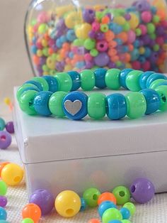 Cute blue and green pony bead bracelet with blue heart charm Blue Heart Charm Jewelry For Friendship, Playful Turquoise Beaded Bracelets With Colorful Beads, Turquoise Heart-shaped Beaded Bracelet, Green Jewelry With Heart Charm And Round Beads, Playful Turquoise Beaded Bracelets, Blue Charm Bracelet With Heart Beads And Adjustable Fit, Playful Blue Beaded Bracelet, Playful Turquoise Beaded Bracelet, Adjustable Blue Charm Bracelet With Heart Beads