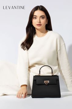 Embrace a classic and timeless style this Winter 2023 with Levantine black handbags paired with all-white cozy outfits. A staple in any fashion capsule, these handbags offer versatility and sophistication across all seasons. Their classic design complements the soft, snug appeal of white outfits, creating a perfect balance of elegance and comfort. #TimelessFashion #Levantinebags #WinterStyle #ClassicTrends #AllWhiteOutfits #FashionEssentials Outfits For Winter 2023, Classic Black Handbag, White Handbags, Beautiful Purse, Fall Bags, Summer Handbags, Vegan Handbags, Stylish Top, Bag Stand