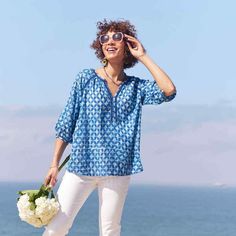 The chic shape of the peasant blouse plus the best color for the season brightened with a subtle shot of lurex. Guaranteed to turn heads! - 90% cotton, 10% lurex - indigo, blue, and white - 3/4 length sleeves with shell buttons - machine wash Blue Split Neck Top For Beach, Indigo Tops For Spring Vacation, Indigo Blouse For Summer, Summer Blue Split Neck Blouse, Blue Split Neck Summer Blouse, Blue Split Neck Top For Vacation, Blue Split Neck Blouse, Blue Cotton Peasant Top For Beach, Blue Bohemian Blouse With Split Neck