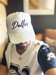 Dallas Hat, D-Town Trucker Hat, Texas Hat, Big D Hat, Cowboy Hat, Football Hat, Gift For Her, White/Navy  Embroidered Foam Trucker Hat Stand out from the crowd with this trendy foam trucker hat! This head accessory is made with high-quality polyester and foam that guarantees a premium look and feel. The foam trucker hat has an adjustable snap that ensures a comfortable fit, and the mesh back provides great breathability. The matching color braid gives the hat an extra oomph. Style it with your f Casual White 5-panel Fitted Hat, White Dad Hat With Embroidered Logo For Baseball Season, White Baseball Cap Dad Hat With Letter Print, White Dad Hat Baseball Cap With Letter Print, White 5-panel Baseball Cap For Baseball Season, White Baseball Hat With Embroidered Logo, White Baseball Cap With Letter Print, White Dad Hat With Letter Print, White 5-panel Hat With Embroidered Logo