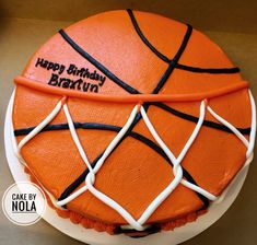 a birthday cake with an orange basketball on it