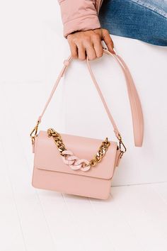 Get date night ready with this chic pink crossbody featuring lightweight faux leather material, a removable and adjustable shoulder strap, a gold large link chain handle with black accent links, and a spacious rectangular pouch with a flap snap button closure and additional inside pockets! Pink Shoulder Bag With Metal Hardware For Evening, Chic Pink Mobile Phone Bag, Pink Flap Shoulder Bag With Adjustable Strap, Pink Shoulder Flap Bag With Adjustable Strap, Chic Crossbody Flap Bag With Chain, Pink Rectangular Bag With Metal Hardware, Chic Flap Bag With Chain Crossbody, Chic Flap Bag With Chain Strap, Chic Pink Flap Bag For Daily Use