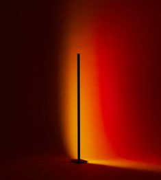 an orange and red background with a black pole