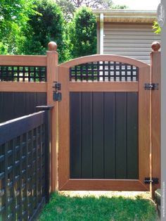 a wooden gate in front of a house