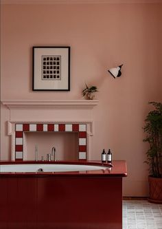 a bathroom with pink walls and a white fireplace