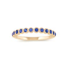 a yellow gold ring with blue sapphire stones