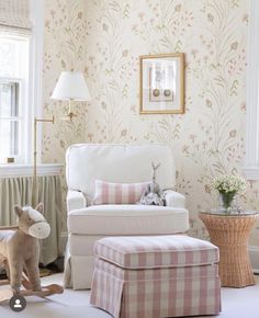 a living room filled with furniture and a baby's rocking chair in front of a window