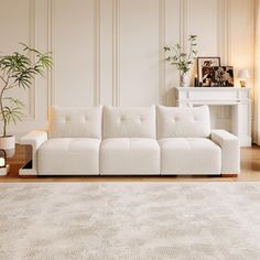 a living room with a white couch and rug