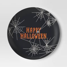 a black plate with spider webs and the words happy halloween written in orange on it