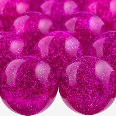 purple glitter balls are arranged in rows on a white background