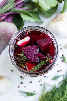 a jar filled with beets and other vegetables