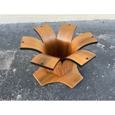 a wooden sculpture sitting on top of cement