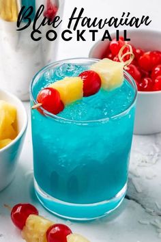 the blue hawaiian cocktail is garnished with pineapple and cherries