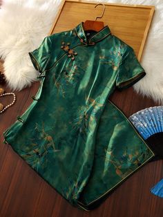 This green qipao is crafted from 95% mulberry silk and 5% spandex, offering a soft feel and elegant drape. Featuring delicate flower buttons, this traditional dress combines classic charm with modern sophistication. Perfect for special occasions, it beautifully highlights your silhouette while ensuring comfort and style. Size Chart:(Dress length about 110cm) S: Shoulder width-36cm, Chest-84cm, Waist-68cm, Hip-88cm M: Shoulder width-37cm, Chest-88cm, Waist-72cm, Hip-92cm L: Shoulder width-38cm, C Green Qipao, Flower Button, Elegant Drapes, Dress Flower, Silk Shorts, Button Flowers, Traditional Dress, Delicate Flower, Cheongsam