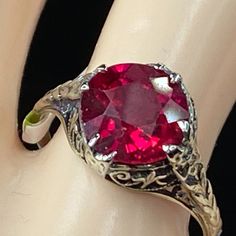 One Antique 14k White Gold Ring, Victorian Design, Circa Approx. 1940-1950's, Ir Prong Set One 8.4mm Synthetic Ruby, Filigree Etching Decorated Throughout The Ring. Weight 2.3gm, No Hallmark, Tested For 14k (1 Inch = 25.4 Mm; 1 Dime = 17.9mm). It Comes With A Complimentary Gift Box. All Jewelry Items Are Pre-Owned Unless Otherwise Stated. This Means They Have The Usual Aspects Of Pre-Owned Jewelry, Such As Light Scratches, Wear And Tarnish. Please Review All The Photos Which Will Be Part Of The Description. Classic Ruby Ring Collectible, Classic Collectible Ruby Ring, Antique Yellow Gold Ruby Ring With Filigree, Hallmarked Vintage White Gold Ruby Ring, Vintage Hallmarked White Gold Ruby Ring, Antique Diamond Cut Ruby Ring For Anniversary, Vintage Filigree Round Cut Jewelry, Ornate 14k Gold Ruby Ring For Anniversary, Antique Hallmarked Round Birthstone Ring