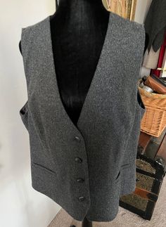 In excellent condition, this vintage grey vest from J Jill in boucle wool blend fabric. Shell is 46% polyester, 21% acrylic, 16% wool, 13% viscose, 1% spandex, 3% other. Lining is 51% polyester and 49% rayon. Made in the Philippines Fitted Wool Sweater Vest For Winter, Fitted Wool Sweater Vest For Fall, Fitted Wool Sweater Vest In Vintage Style, Gray Winter Workwear Vest, Fitted Gray Sweater Vest For Fall, Gray Fitted Sweater Vest For Fall, Tailored Wool Vest For Winter, Fitted Gray Sweater Vest For Winter, Formal Wool Vest For Winter