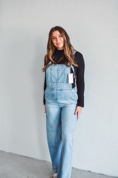 This Everyday Denim Jumpsuit is a must-have for the fashion-forward. Made with stretchy material for a comfortable fit, it features an adjustable strap and a side zipper closure for a perfect fit. The front single pocket and back/front pockets add convenience and style. Elevate your everyday look with this chic and versatile jumpsuit. Model #1 is wearing size Small, and Model #2 is wearing size Medium. Material: 73% Cotton, 27% RayonCare:Machine wash cold, dry on low, iron low. Available in both Medium Wash Denim Overalls With Side Pockets, Utility Light Wash Jumpsuits And Rompers In Overall Style, Medium Wash Overall Jumpsuits And Rompers With Side Pockets, Utility Light Wash Overall Jumpsuit, Trendy Light Wash Overalls For Workwear, Trendy Denim Jumpsuit With Zipper Closure, Trendy Light Wash Jumpsuits And Rompers For Work, Casual Denim Jumpsuit With Zipper For Spring, Casual Denim Jumpsuit With Zipper Closure