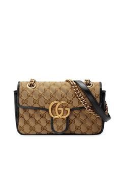 Crafted from beige the original GG canvas and trimmed with black leather, this small-scale Gucci accessory is just the thing for keeping all of your essentials close by. Featuring a chain and leather shoulder strap, a front flap closure, a clasp fastening, shiny gold-tone hardware, an internal slip pocket, black leather trims, the original GG canvas, and Double G logo. Depth: 6cmHandle: 30cmHeight: 13cmStrap: 55cmWidth: 22cm Gg Marmont Matelassé Mini Bag, Gucci Gg Marmont Matelasse, Gucci Runway, Double G Logo, G Logo, Gucci Gg Marmont, Buy Gucci, Gg Marmont, Gucci Accessories