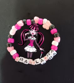 This is a Draculaure themed Kandi Bracelet. This is perfect for fans of our favorite pink vampire and vegan. Themed Pink Bracelets For Birthday, Personalized Pink Novelty Charm Bracelet, Pink Themed Birthday Bracelets, Pink Adjustable Themed Charm Bracelet, Adjustable Pink Themed Charm Bracelet, Pink Themed Adjustable Charm Bracelet, Customized Pink Novelty Jewelry, Customizable Pink Novelty Jewelry, Customizable Novelty Pink Jewelry