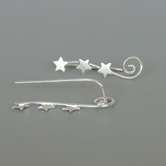 Sterling silver ear climber with tiny stars. This listing is for ONE PAIR Size: 22 x 5 mm These earrings are made of real 925 hypoallergenic sterling silver. All my pieces are sent in a gift box. I can include a personal message from you if needed You are welcome to contact me at... bhavnakwintra1956@gmail.com For more beautiful pieces from my shop, please browse 👇 TOE RINGS: https://www.etsy.com/your/shops/TheSilverGame/tools/listings/section:27020628,view:table EAR HOOPS: https://www.etsy.com Star-shaped Ear Climbers As Gift, Star-shaped Ear Climbers For Gift, Star Shaped Ear Climbers As Gift, Star-shaped Ear Climbers For Pierced Ears, Leaf Earrings Silver, Stars Earrings, Silver Ear Climbers, Silver Star Earrings, Ear Climber