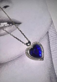 🛍️ Brand vintage one off piece  ❤️Style 90's necklace pendant  ✂️ Condition Vintage condition with normal signs of wear and tear. 🏳️🌈 Colour blue  women's  🏷️ Size 18 '' chain  📎 Material  silver plated chain  💌 Message me any questions  💎 Own a piece of history 👑 perfect one of piece of jewellery  🔮 magical gift with its own once upon a time  story fairy tale 📖 Happily ever after .... comes gift wrapped 🎁 Silver Heart-shaped Crystal Necklace With Clavicle Chain, Blue Heart Cut Jewelry For Party, Blue Heart Pendant Clavicle Chain Jewelry, Blue Crystal Pendant Necklace With Clavicle Chain, Blue Necklace With Heart Charm, Blue Necklace With Round Heart Charm, Blue Jewelry For Valentine's Day Party, Blue Necklaces With Heart Charm And Round Shape, Blue Gemstone Heart Cut Necklace