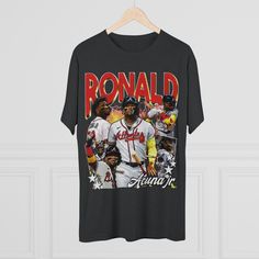 Introducing the Ronald Acuña Jr. 90's Bootleg Vintage T-Shirt - a nostalgic tribute to one of baseball's brightest stars! Channeling the iconic style of the 1990s, this t-shirt seamlessly blends retro aesthetics with the electric energy of Acuña's game. Design: Our vintage-inspired design captures the essence of the '90s bootleg culture. The graphic features an eye-catching mix of vibrant colors, bold typography, and psychedelic patterns that pay homage to the era's DIY fashion. Ronald Acuña Jr. Streetwear Graphic T-shirt For Baseball Season, Sports Fan Baseball Jersey With Graphic Print, Throwback Short Sleeve Baseball Jersey Sports Season, Graphic Print Short Sleeve Baseball Jersey For Sports Fans, Throwback Sports T-shirt With Relaxed Fit, Throwback Relaxed Fit T-shirt For Sports, Graphic Print Baseball Jersey For Fans, Sports Fan Tops For Baseball Season Streetwear, Fan Apparel Baseball Jersey With Graphic Print