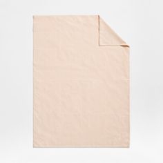 the pink blanket is folded up on a white surface with an empty sheet underneath it