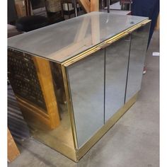 a large metal and glass cabinet sitting in a room next to other items on the floor