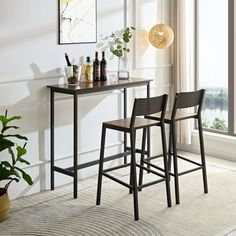 two bar stools sitting next to each other in front of a table with bottles on it