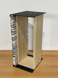 a wooden book stand with many books in it