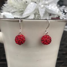 Sparkly Red Pave Rhinestone Crystal Ball Earrings. These earrings dangle from silver-plated hook ear wires. Sparkly and festive for the holidays. Beads are 10mm. Nickel-free Red Crystal Earrings, Red Nickel-free Crystal Earrings, Red Ear Wire Earrings For Holiday, Red Round Earrings For Christmas, Red Ear Wire Jewelry For Holidays, Holiday Red Ear Wire Earrings, Red Holiday Earrings With Ear Wire, Red Hypoallergenic Jewelry For Party, Red Hypoallergenic Party Jewelry