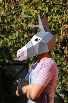 a person wearing a paper horse mask on their head