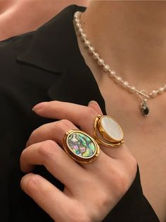 Discover the exquisite elegance of our Abalone Shell Ring, featuring a versatile double-sided design with natural abalone and white shells. Crafted from high-quality brass plated with 18K gold, this luxurious piece embodies nature's beauty and fine craftsmanship. Specifications: - Item Weight: Lightweight and comfortable at 0.06 mils of gold plating. - Metals Type: Stainless Still. - Material: 18K gold plated, combined with natural abalone and white shell. Care Instructions:  * Protect your jewelry from scratches.  * Avoid exposure to harsh chemicals.  * Store your jewelry away from direct sunlight in a microfiber pouch.  * Clean with warm water and detergent-free soap; thoroughly dry before storing.  * Use a microfiber cloth to polish and maintain the shine of your pieces.  Shipping Detai Luxury Abalone Shell Jewelry Gift, Gold Mother Of Pearl Rings For Anniversary, Gold Mother Of Pearl Anniversary Rings, Gold Mother Of Pearl Ring For Gift, Gold Mother Of Pearl Ring As A Gift, Elegant Gold Shell-shaped Rings, Elegant Shell-shaped Gold Rings, Gold Shell-shaped Ring For Gift, Gold Shell-shaped Gift Ring