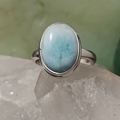 Natural Blue Larimar Ring Set In .925 Solid Sterling Silver. This Pendant Is 5.81cts And Weighs 4.15 Grams. Larimar Is Mined Only One Place On Earth And That Is From The Volcanic Mountains In The Dominican Republic. It Is A Stone That While It Was Created In The Hot, Red, Magma Tubes Of A Volcano, Is A Cool Spectrum Of Blues And Teals Webbed With White Patterns That Remind Us Of Both The Surf And Sky Of The Caribbean. It Is No Surprise That The Color And Feel Of This Stone Brings Joy, Happiness Sun People, Volcanic Mountains, Larimar Ring, Larimar Rings, Brings Joy, The Dominican Republic, Women Artisans, Dominican Republic, The Caribbean