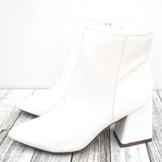 These Newly Arrived Block Heel Booties Will Instantly Update Your Outfits. New In Box Vegan Leatherette Material Lightly Padded Insole Side Zipper For Easy Shoe Removal Chunky Asymmetrical Block Heels Approximate Heel Height: 3.5 In. Fitting: True To Size. Regular Foot Width. Trendy White Heeled Boots With Block Heel, Trendy White Block Heel Boots, Trendy White Boots With Block Heel, White Stacked Heel Ankle Boots, Trendy White Booties With Block Heel, White Block Heel Booties For Fall, Trendy White Booties With Stacked Heel, White Booties With Stacked Block Heel, White Booties With Stacked Heel