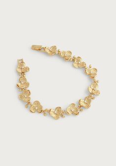 Fashioned from 18k gold dipped brass accented with hand set crystal. The sculpts of the bracelet are thoughtful and lightweight, making this extraordinary piece as beautiful as it is comfortable to wear. Elevate your look with the effortless glamour of this Orchid Link Bracelet. Opulent 18k gold dipped brass accentuated with meticulously hand set crystals showcase a sleek and timeless design. The thoughtful, lightweight construction guarantees comfort and ease of wear. Adorn yourself with this l Elegant Gold-plated Bracelet, Gold-tone Jewelry With Oyster Bracelet In Gold Plated, Gold-tone Jewelry With Oyster Bracelet For Formal Occasions, Gold-tone Oyster Bracelet Luxury Jewelry, Elegant Gold Brass Bracelet For Formal Occasions, Formal Gold-tone Jewelry With Oyster Bracelet, Elegant Plated Chain Bracelet, Elegant Plated Bracelets, Elegant Yellow Gold Brass Bracelet