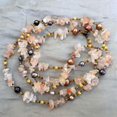 The semi precious peach quartz nuggets that I have used in this bohemian necklace range in color from clear to cream to light peach. In combination with multicolor pearls, small filigree gold tone accents, and silver lined buggle beads, they create a striking Wabi Sabi ("beautiful imperfection") effect.  This gemstone necklace is extra long, 50 inches (126 cm).  You can wear it as one very long strand, flapper-style, double wrap, or even triple wrap it for an especially rich layered look. It would make a great special occasion accessory, or a bridal necklace for a  boho chic wedding. Pearl is a June birthstone Many more extra long multi wrap necklaces are here: https://www.etsy.com/shop/ALFAdesigns?section_id=12558581 To see all artisan ALFAdesigns jewelry, please visit  https://www.etsy.c Bohemian Coral Necklaces With Natural Stones, Bohemian Coral Necklace With Natural Stones, Bohemian Peach Round Beads Jewelry, Bohemian Orange Crystal Necklace With Natural Stones, Orange Bohemian Crystal Necklace With Natural Stones, Bohemian Rose Quartz Beaded Necklace, Bohemian Rose Quartz Crystal Necklaces With Gemstone Beads, Bohemian Rose Quartz Crystal Necklace With Gemstone Beads, Bohemian Rose Quartz Gemstone Necklace