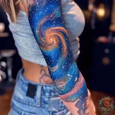 a woman with a tattoo on her arm that has an image of the stars in the sky