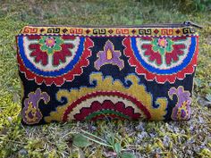 "Small Silk Petit Point Clutch, Handbag Organizer, Make Up Organizer created and handmade in Uzbekistan. Lined with silk and cotton fabric, zipper top.  Each clutch is hand drawn on to cotton canvas, inspired by original designs from Uzbekistan history.  Measures 6\"  high x 10\" width, 9\" opening  Embroidery the same on the front and the back of the clutch Can fit largest sizes of iPhone and Android. 100% silk petit point with handwoven silk and cotton lining. Your purchase preserves and encou Handmade Tapestry Bag For Gift, Traditional Handmade Clutch With Multicolor Embroidery, Traditional Black Clutch, Traditional Handwoven Clutch Bag, Traditional Tapestry Bag In Rectangular Shape, Traditional Tapestry Rectangular Bag, Traditional Rectangular Tapestry Bag, Traditional Multicolor Handmade Clutch, Bohemian Ceremonial Rectangular Bag