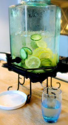 a pitcher filled with water and sliced cucumbers