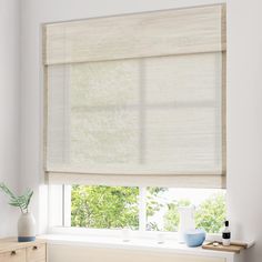 a window with blinds in the corner and a vase next to it on a dresser