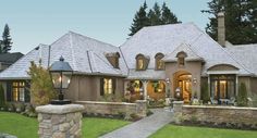 a large house with lots of windows and stone pillars in front of it's entrance